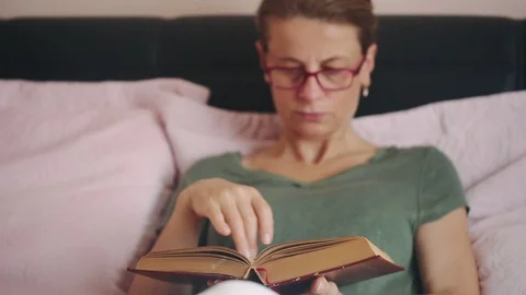 Reading a book Video stock 92542217