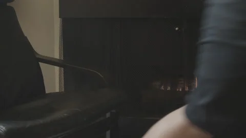 Reading book by gas fireplace Video stock 130844689