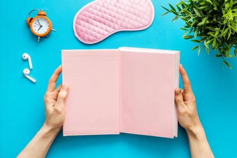 Reading book before going to bed. Sleeping accessories on the table, top view Stock Photos