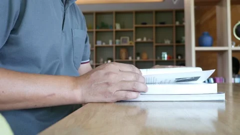 Reading a book in the library room Stock Footage 186415224