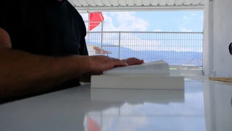 Reading a book, open a book with city background Video stock 204079428