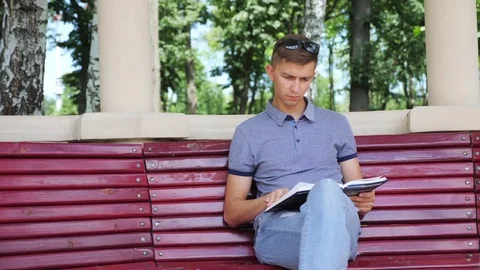 Reading Book In the Park Stock Footage 78334846