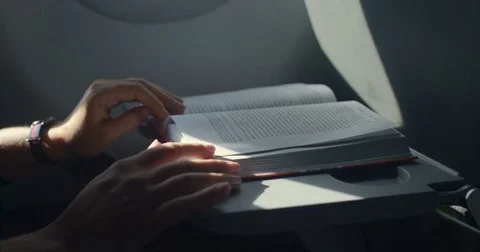 Reading a book in the plane Stock Footage 80252630