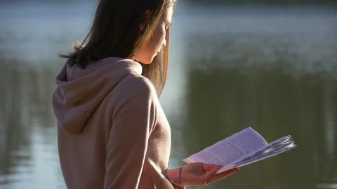 Reading a book on a pond Stock Footage 75993809