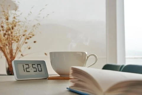 Reading book on the table with a cup of hot coffee Stock Photos
