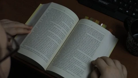 Reading a Book on a Table, HD Video stock 127001924