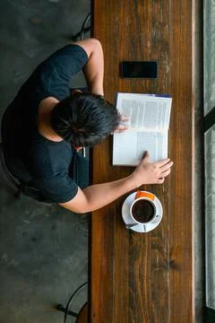 Reading book while drinking coffee Foto stock