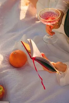 Reading  book while enjoying summer fruits and drinks on  sunny afternoon out Foto stock