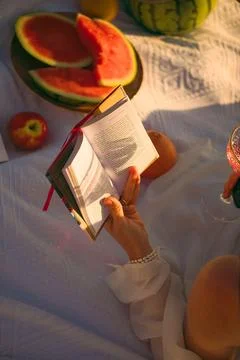 Reading  book while enjoying summer fruits and drinks on  sunny afternoon out Stock Photos