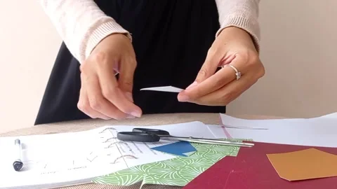 Reading the box of the white flower with a bottle of perfume on a table Stock Footage 146253119