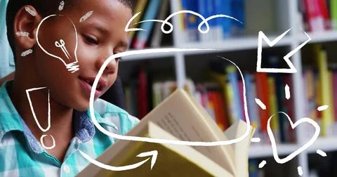 Reading boy in teal checked shirt holding open hardcover book in library, white Stock Photos