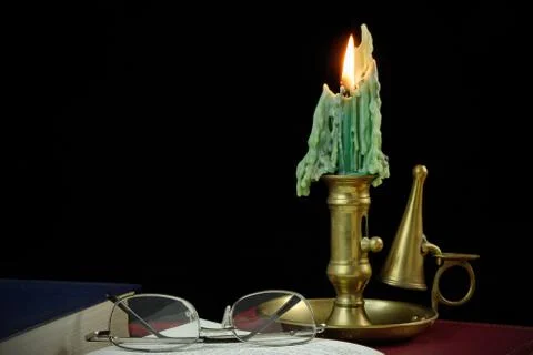 Reading by candle light Stock Photos
