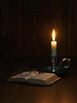 Reading by candlelight 스톡 사진