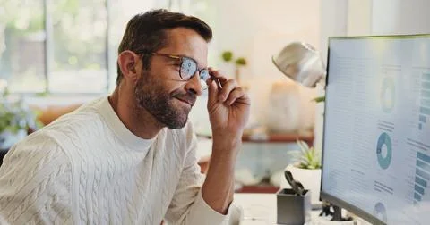 Reading, charts and man on computer in home for review of graphs for report Stock Photos