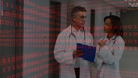 Reading clipboard doctors pointing, confirming notes in hospital corridor lab Stock Footage 334036596