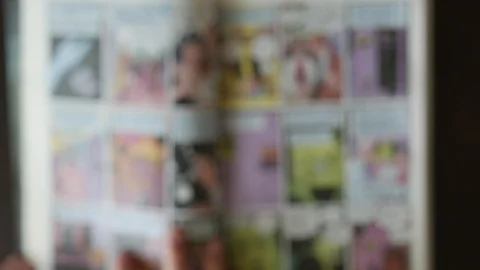 Reading comic book - top-view blurry defocused concept video Video stock 92525446