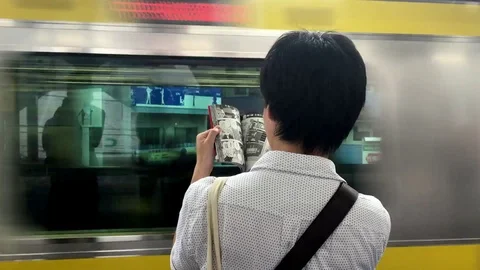 Reading comics subway Video stock 98677479