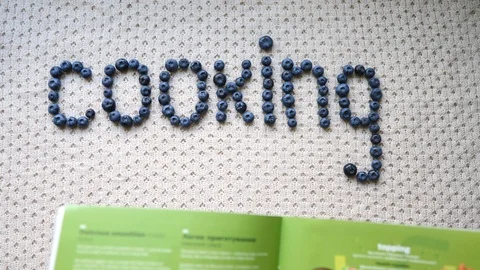 Reading Cook Book While Cooking In Kitchen Stock Footage 112606691
