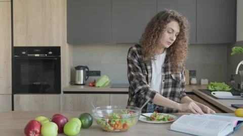 Reading Cookbook While Eating Salad In Bright Cozy Kitchen Interior Scene Stock Footage 311270924