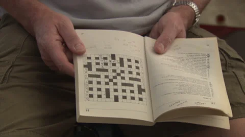 Reading a crossword puzzle Stock Footage 39485112
