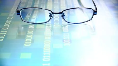 Reading data in digital age. glasses and flowing binary code matrix. shallow Stock Photos