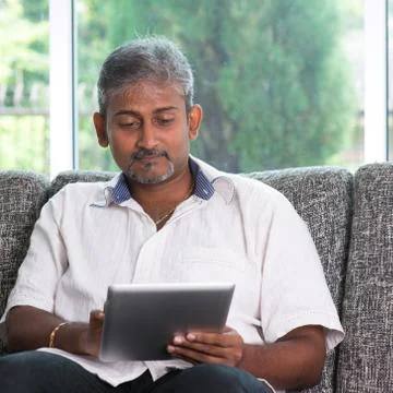 Reading on digital tablet computer Stock Photos