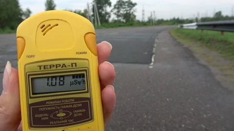 Reading of dosimeter and an old bus passing on the road in vicinity of the Ch Video stock 114615270