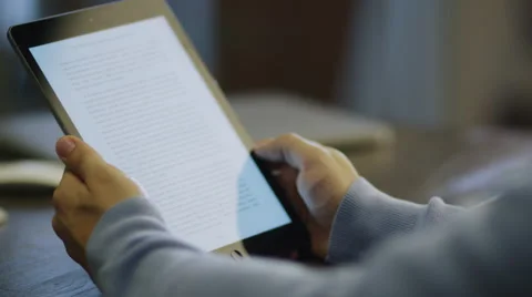 Reading eBook on Digital Tablet in Office at Evenin Stock Footage