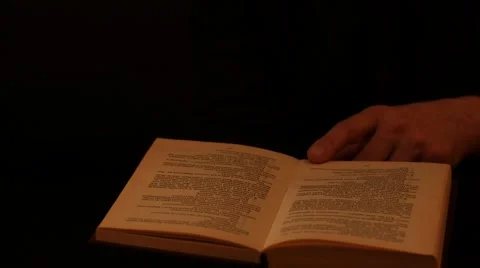 Reading fast motion isolated hand over book black background Stock Footage 57886019