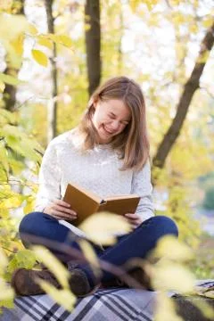 Reading girl laugh Stock Photos