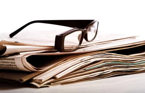 Reading glasses on newspapers Stock Photos