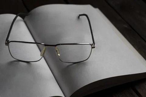 Reading Glasses on Open Book Foto stock