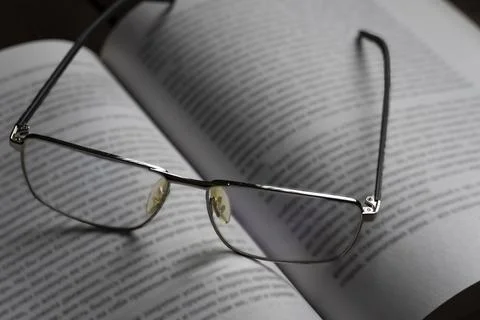 Reading Glasses on Open Book Stock-Fotos