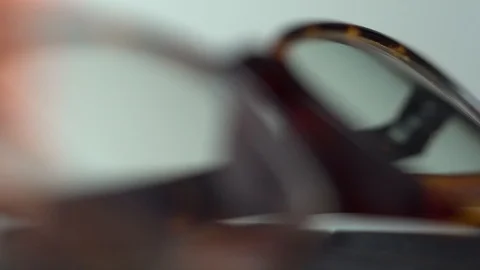 Reading glasses select focus shallow depth of field light sweep shadow Stock Footage 119078813