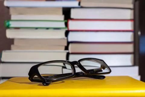 Reading glasses on a stack of books with selective focus for education concep 스톡 사진