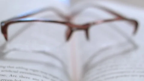 Reading Glasses On Top of an Open Book, Zoom In  Vidéo 76766954