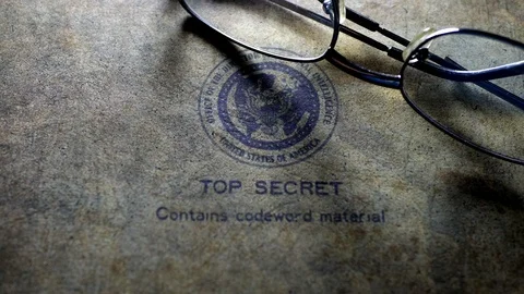Reading glasses on top secret document Stock Footage 113745253