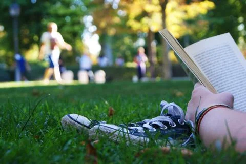 Reading on the grass Stock Photos