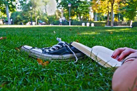 Reading on the grass Stock Photos