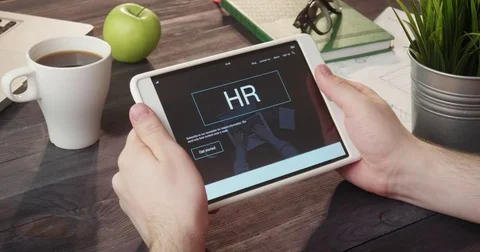 Reading hr internet page using digital tablet at desk Stock Footage