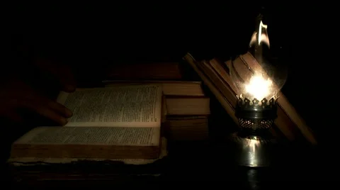 Reading at kerosene lamp Stock Footage 11701877
