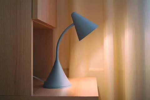 Reading lamp on bedside table made of wood Foto stock