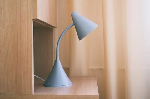 Reading lamp on bedside table made of wood Stock Photos
