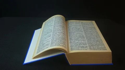 Reading a large book in a studio Stock Footage 92578963