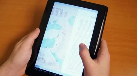 Reading Magazine On Tablet Touch Screen Stock Footage 18174039