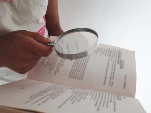 Reading with magnifier over white Stock Photos