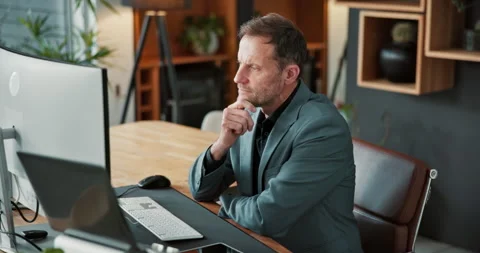 Reading, man and thinking with computer in office for market timing, trading Stock Footage 341573072