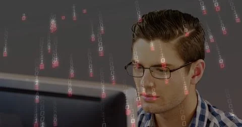 Reading man with rectangular glasses and blue-check shirt at desk, viewing 写真素材
