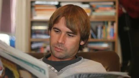 Reading the Newspaper Stock Footage 10897606