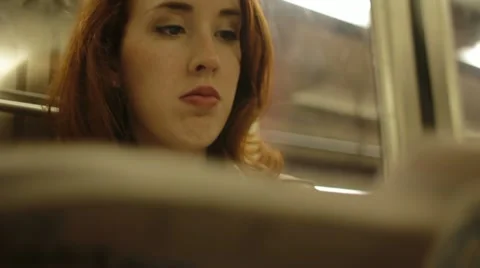 Reading newspaper on subway Stock Footage 22636705